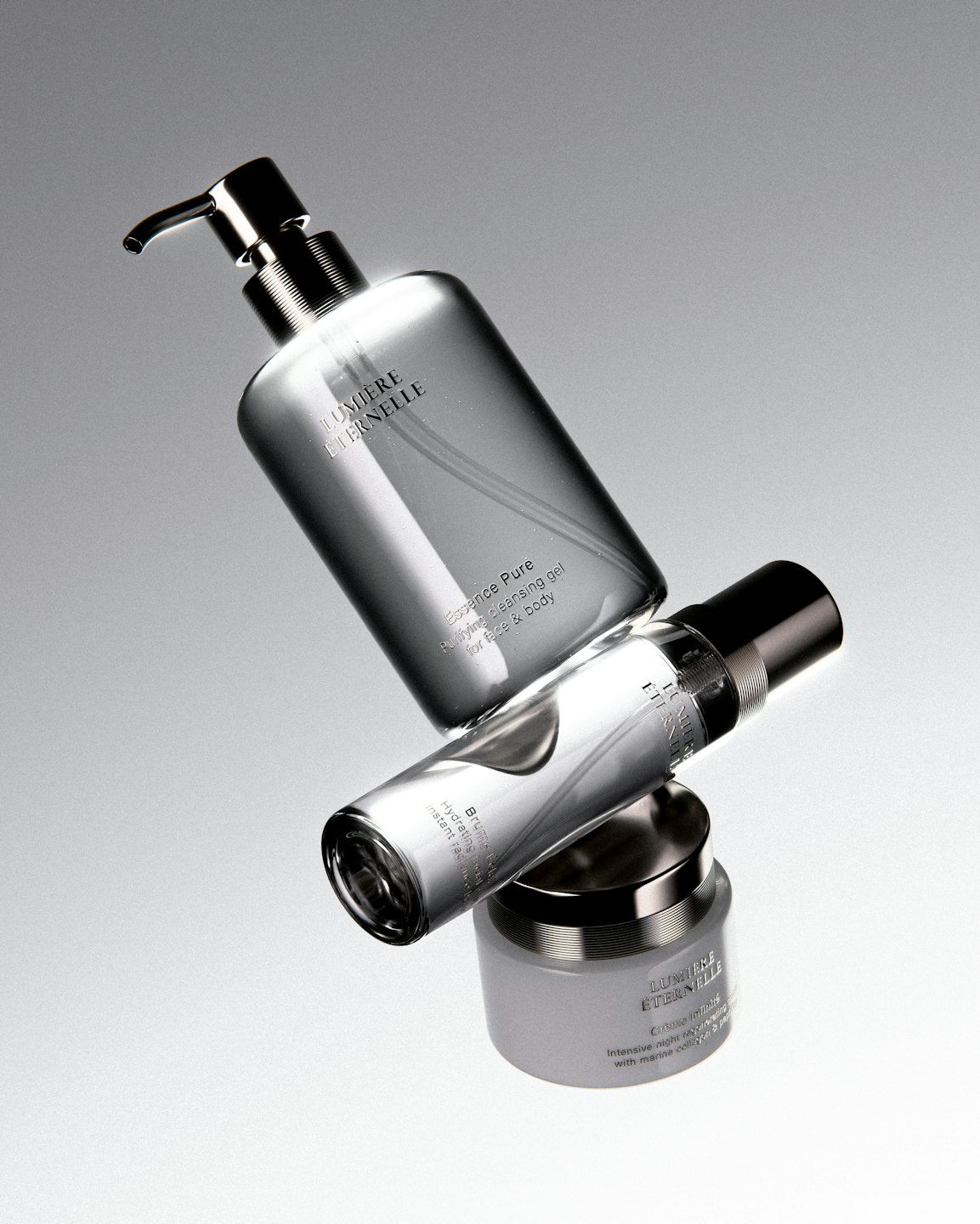 Three minimalist skincare products stacked on a grey background.