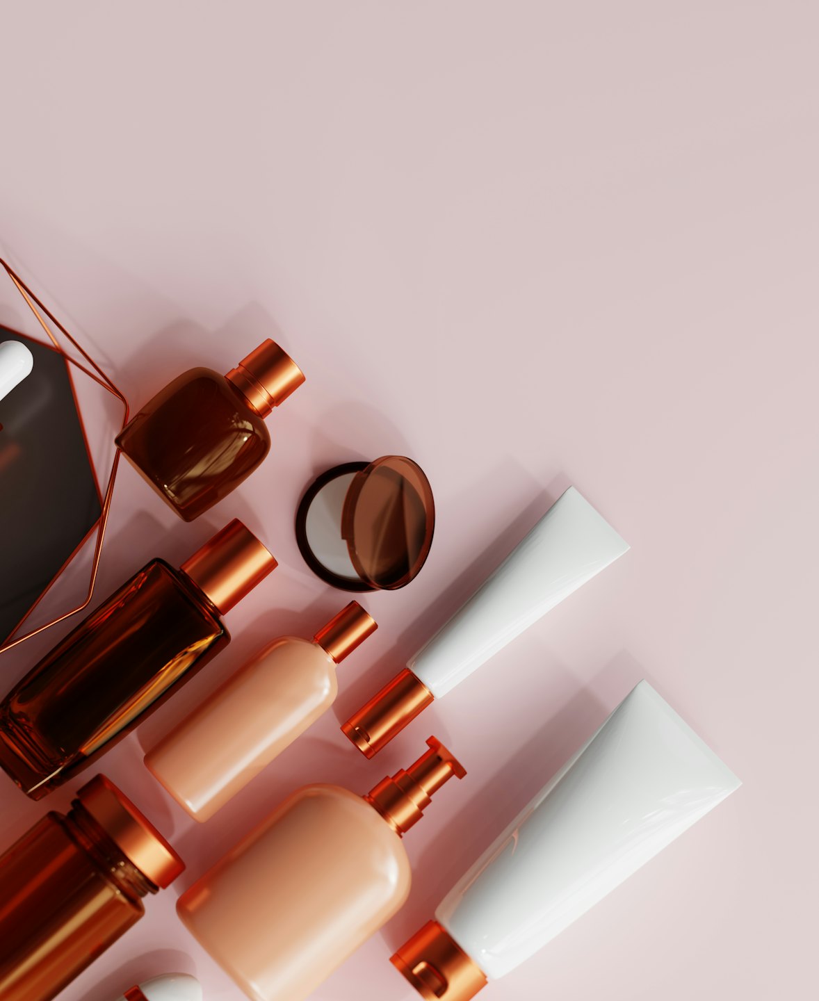 Cosmetic and skincare products arranged on a pink background.
